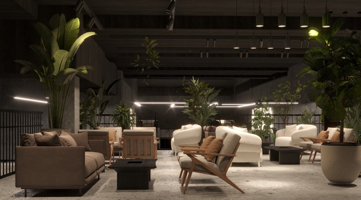 Hotel lounge interior with taupe and cream seating, timber-framed armchairs, large indoor plants and linear pendant lighting beneath a dark ceiling